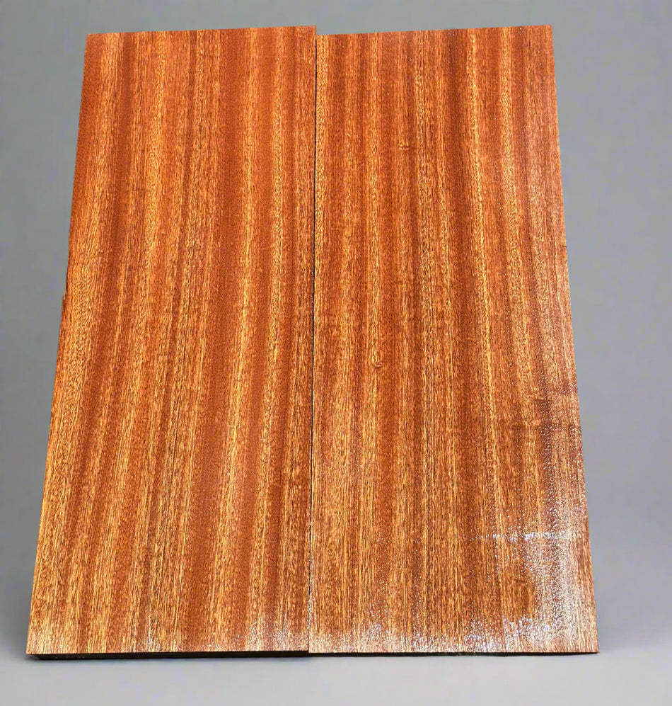 Wooden panel with a reddish-brown finish on a dark textured background
