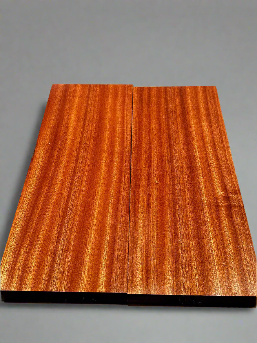 Two wooden planks with a visible grain pattern on a dark background