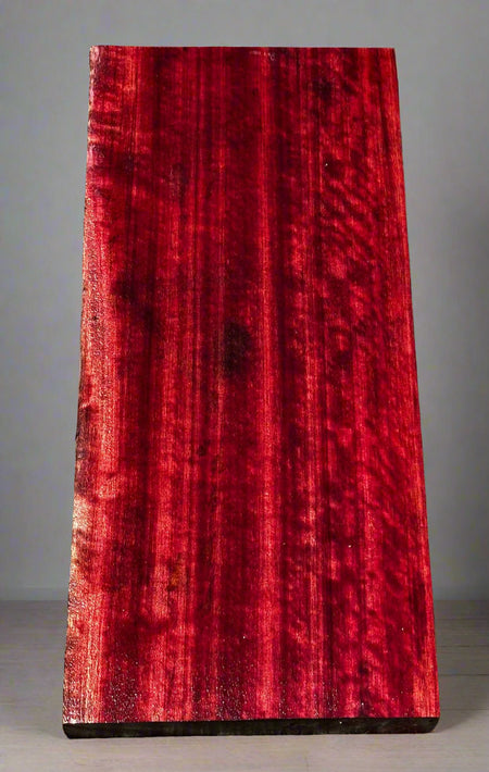 Red wooden slab on a gray surface