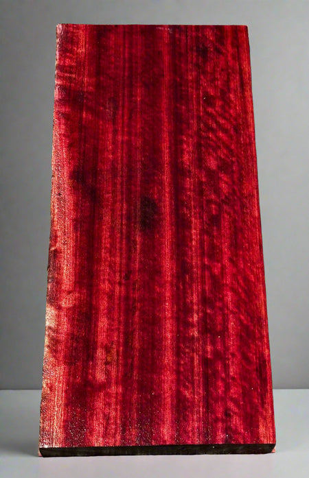 Red wooden slab on a gray surface