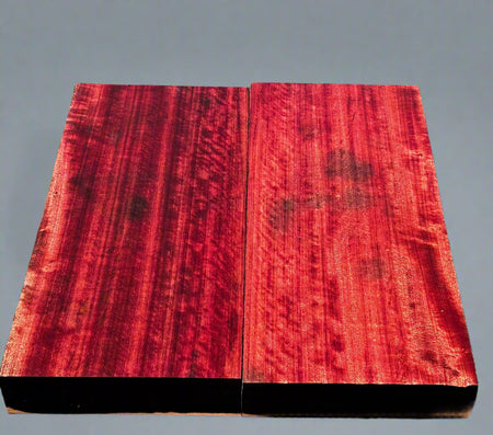 Red wooden board with a black border on a dark surface