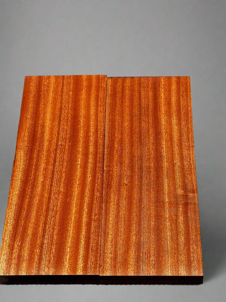Wooden panel with a clear finish on a textured black background
