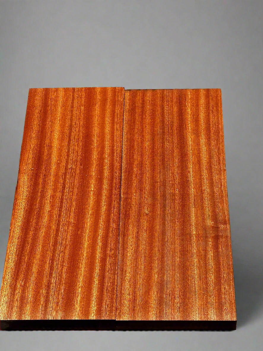 Wooden panel with a clear finish on a textured black background
